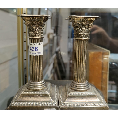 436 - A pair of Corinthian column hallmarked silver candlesticks, Birmingham 1905, height 14cm