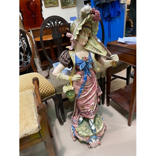 208 - A large majolica style figure of a girl in bonnet, ht 100cm