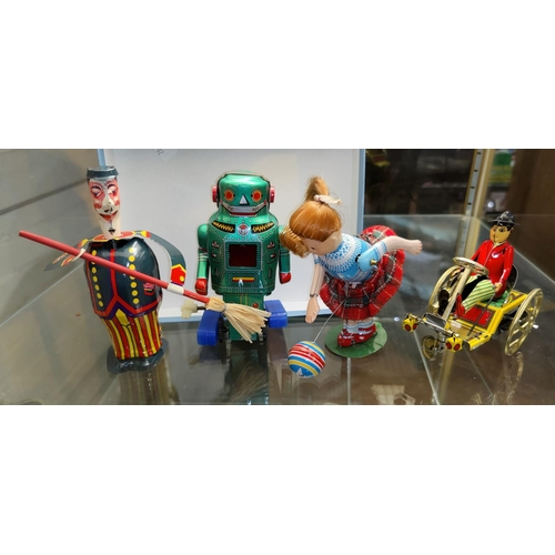 792 - A Vintage Japanese tin plate clockwork robot and three other tin plate toys
