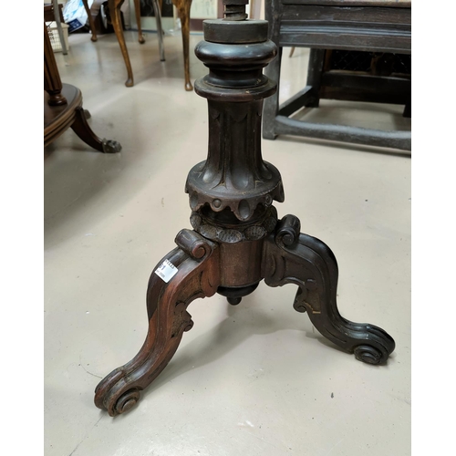 23 - A Victorian circular piano stool with carved tripod base.