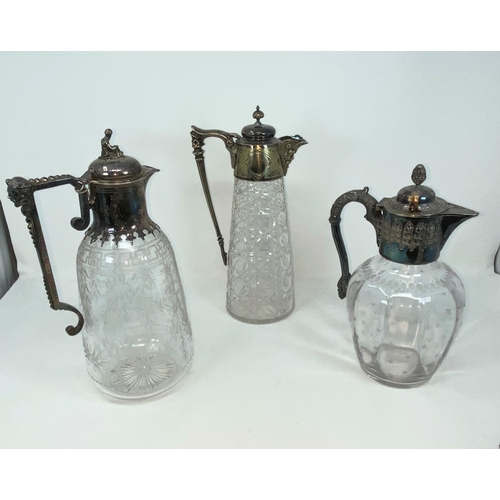 201 - Three Victorian cut/etched claret jugs with silver rims, collars and handles