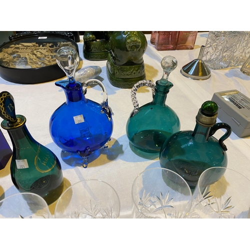 205 - Two 19th century green glass claret jugs; a green 'Brandy' decanter; a turquoise glass wine jug
