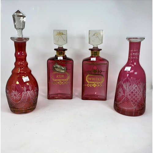 207 - A pair of pink rectangular decanters, lettered in gilt 'Whisky' & 'Rum'; 2 pink overlaid decanters (... 