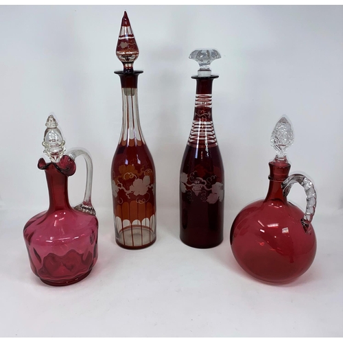 208 - Two 19th century ruby overlaid decanters (1 replacement stopper); 2 cranberry claret jugs