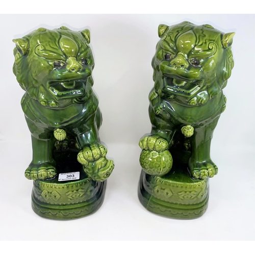 303 - A Chinese pair of modern dogs of Fo with green glaze, height 36 cm