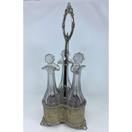 321 - A 19th century decanter in pierced and cast silver plate, central ring handle, with 3 slice cut deca... 