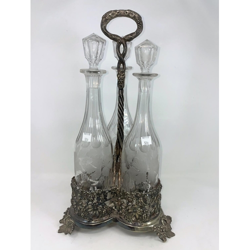 322 - A 19th century 3 bottle decanter stand with extensive vine relief decoration, with 3 vine etched gla... 