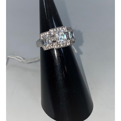 358 - A 9 carat hallmarked gold dress ring set 3 large cushion cut diamond simulants and multiple smaller ... 