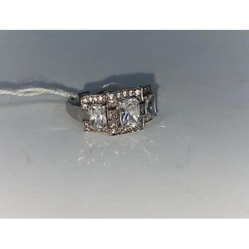 358 - A 9 carat hallmarked gold dress ring set 3 large cushion cut diamond simulants and multiple smaller ... 