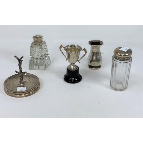 388 - A small silver vase; a silver ring tree; silver top bottles; etc., various dates, total weighable si... 