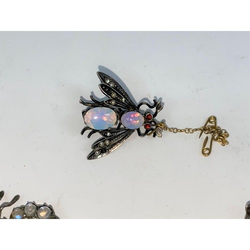395 - Three novelty brooches set with various stones - a fly with opal effect body and red eyes, a scorpio... 