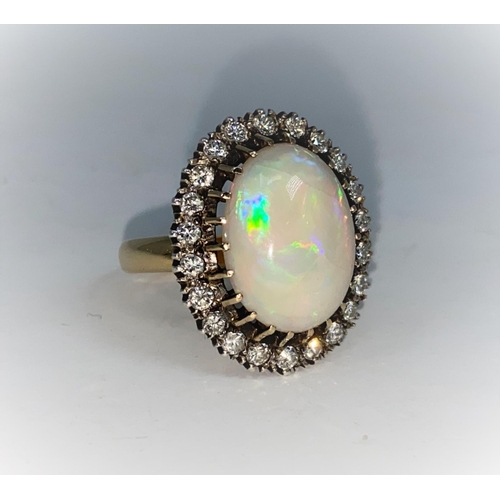 362 - An large oval opal and diamond dress ring stamped 18 ct, 22 diamonds, size Q, gross 10.6g