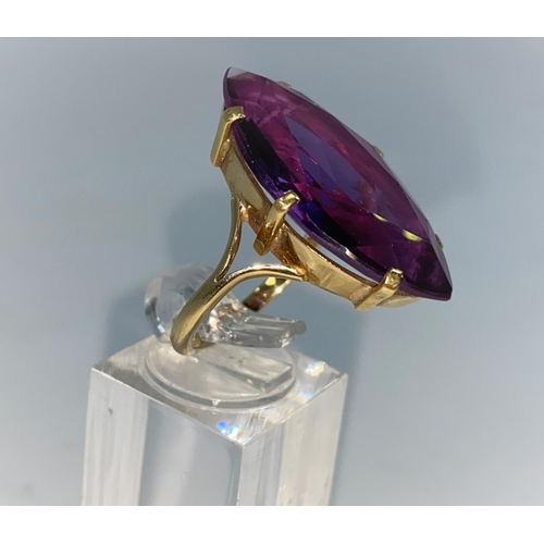372 - A yellow metal dress ring set with large marquise style amethyst, shank unmarked tests as 9/10 carat... 