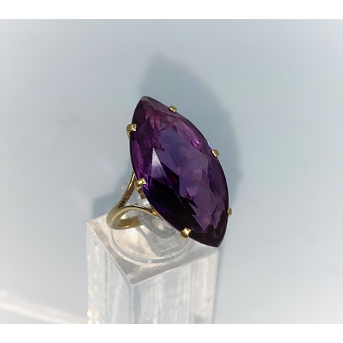 372 - A yellow metal dress ring set with large marquise style amethyst, shank unmarked tests as 9/10 carat... 