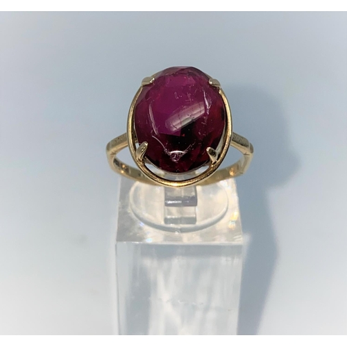 375 - A 9 carat hallmarked gold dress ring set with large oval cabochon garnet, size O, 4.5gm