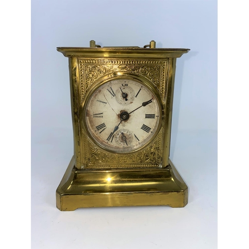 135 - A 19th century American brass mantel / alarm clock in the style of a carriage clock