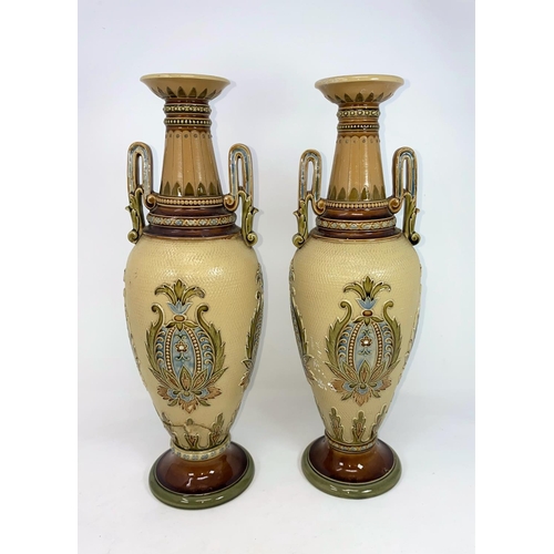 165 - A pair of Mettlach stoneware baluster vases with Art Nouveau decoration against a light brown ground... 