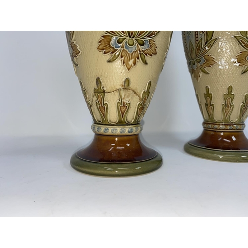 165 - A pair of Mettlach stoneware baluster vases with Art Nouveau decoration against a light brown ground... 
