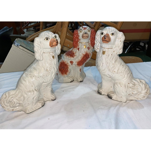 180 - A 19th century pair of King Charles spaniels with painted faces; a similar dog