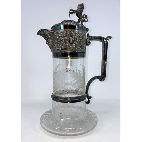 194 - A 19th century fan etched claret jug with lion and shield finial, embossed silver plated rim and han... 