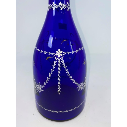 209 - A Georgian Bristol blue decanter, mallet shaped and decorated with swags and garlands in white ename... 