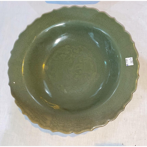 282A - A Chinese octagonal celadon glaze dish with incised floral decoration, diameter 36cm; a Chinese cela... 