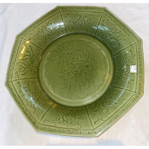 282A - A Chinese octagonal celadon glaze dish with incised floral decoration, diameter 36cm; a Chinese cela... 