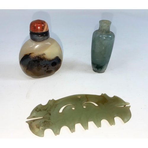 296A - A Chinese jade coloured hard stone comb, a small jade coloured snuff bottle and another