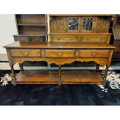 487 - An 18th century style distressed oak dresser base in the manner of Titchmarsh & Goodwin, with 3 frie... 