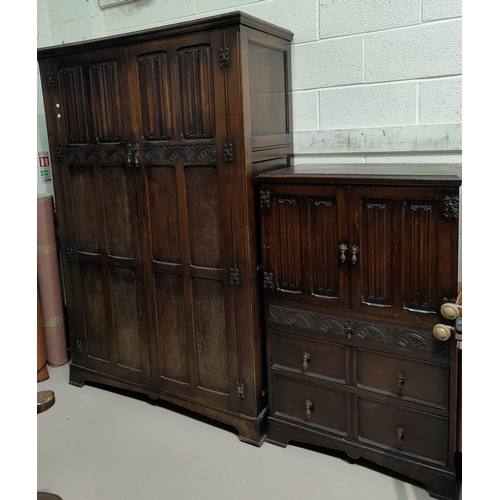 522 - An oak period style double wardrobe with carved linenfold panel doors, 120 cm; a tallboy