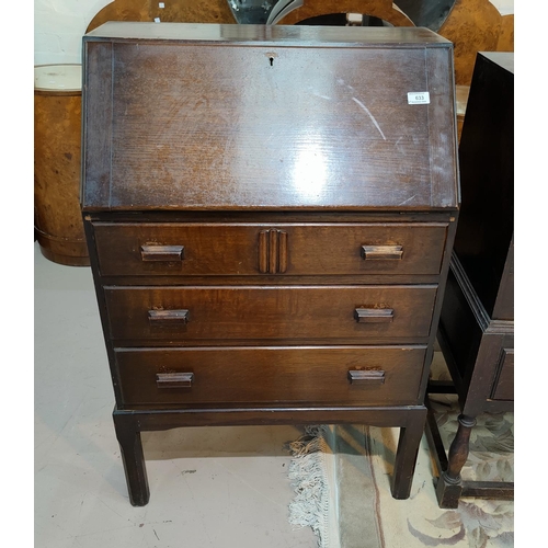 633 - A 1930's oak bureau with fitted interior and 3 drawers