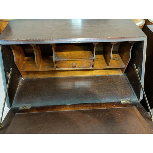 633 - A 1930's oak bureau with fitted interior and 3 drawers