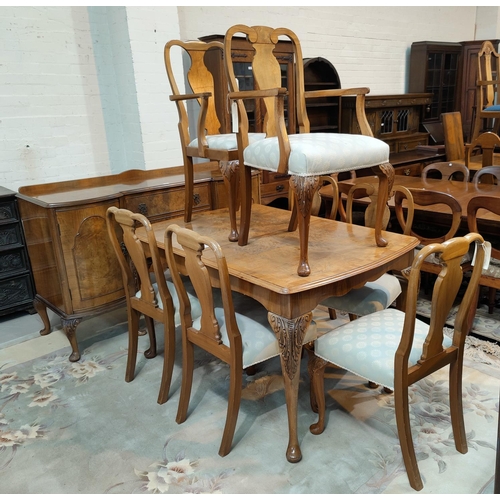 644 - A period style burr walnut dining suite, comprising: a large extending dining table, 6 chairs (5+1),... 