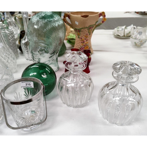 215 - Two cut glass decanters; a similar ice pail; a glass figure of a ladies head; cranberry glass items
