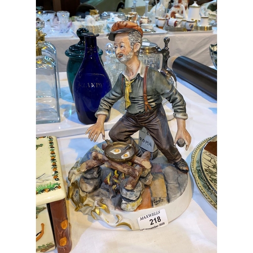 218 - A Capodimonte figure of a tramp frying eggs
