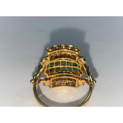 361 - A 1970's diamond and emerald dress ring with 4 rows of 5 diamonds and 3 rows of emeralds, shank 22 c... 