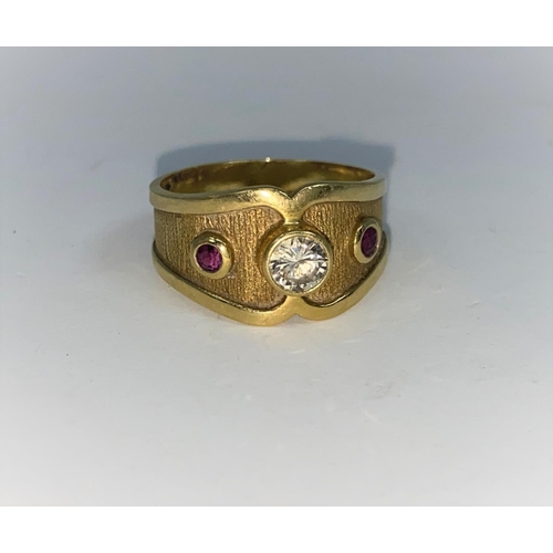 363 - A Victorian style 18 carat hallmarked gold ring with wide shaped shank set with 2 rubied and a diamo... 