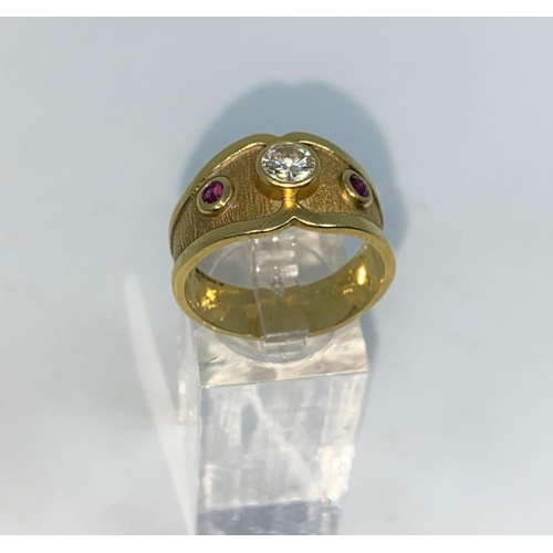363 - A Victorian style 18 carat hallmarked gold ring with wide shaped shank set with 2 rubied and a diamo... 