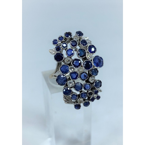 366 - A 1970's lady's modernist multi stone diamond and sapphire ring on white metal shank stamped 18ct an... 