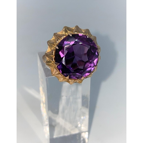 371 - A yellow metal dress ring set with circular facetted amethyst, Middle Eastern marks, tests as 14 car... 