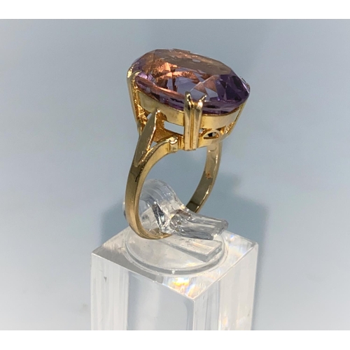 379 - A yellow metal dress ring set with large oval amethyst, unmarked, size N, 6,5gm