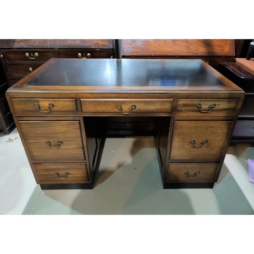 517 - A mid 20th Century pedestal desk with 7 drawers.
Length:- 129cm; width:- 75.5cm; height:- 78cm