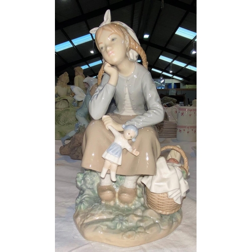 256 - A Lladro group:  seated girl with doll and basket