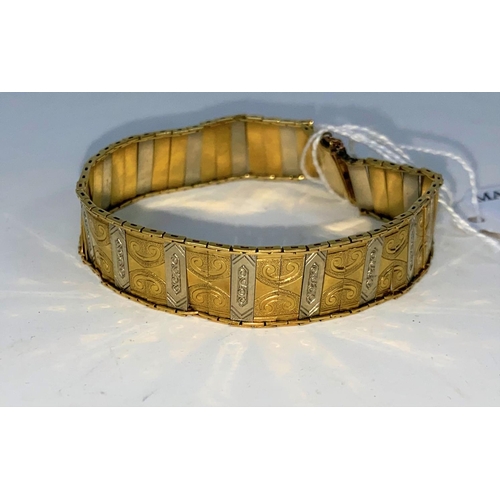 380 - A two tone yellow and white gold chased bracelet, stamped 18K G M, 18gm