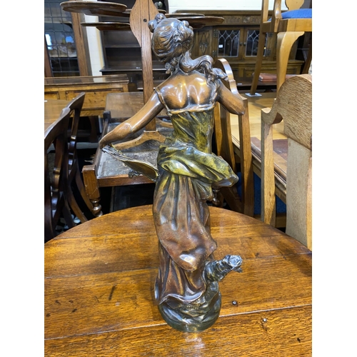 478 - An Art Nouveau patinated spelter figure of a young woman with pen and scroll, height 47cm (finger a.... 