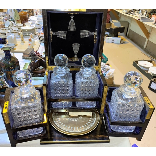 150 - A 19th century Coromandel cased 4 bottle Tantalus with hinged top containing 4 later glasses & hinge... 