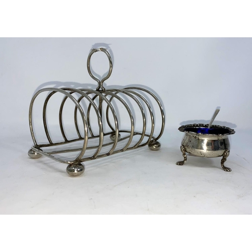 326 - A hallmarked silver arched toast rack of 6 divisions, on bun feet, Birmingham 1903; a silver small c... 