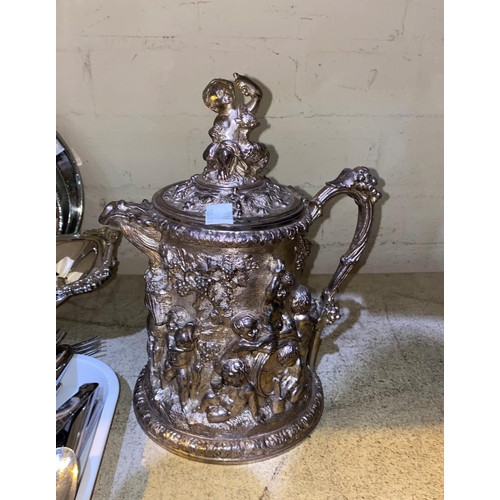 346 - A silver plated ornate wine jug in the style of Cellini; a brass wine jug; a large pewter mounted st... 