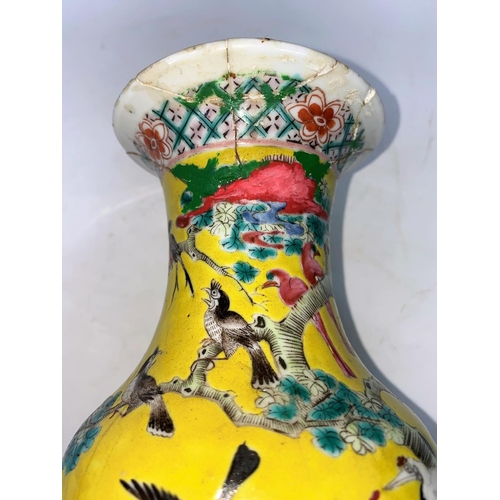 283a - A Chinese famille jaune baluster vase with intricate enamel decoration of birds, flowers and foliage... 