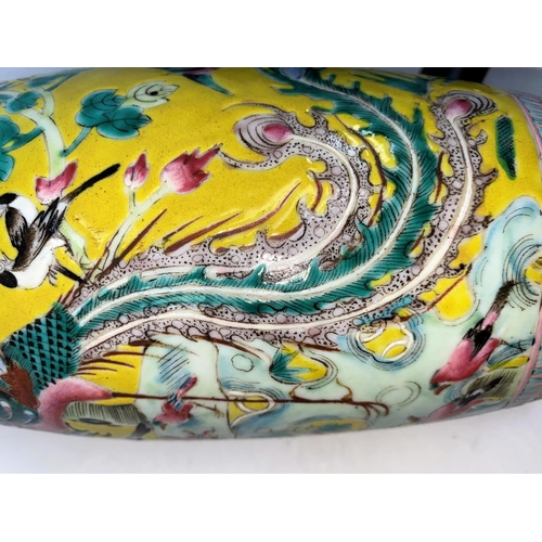283a - A Chinese famille jaune baluster vase with intricate enamel decoration of birds, flowers and foliage... 